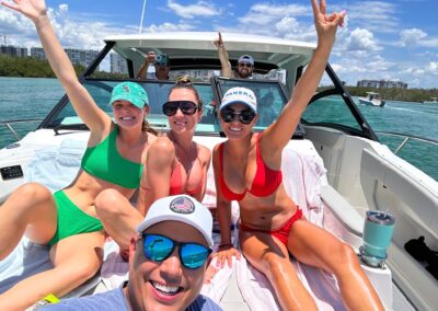 Friends enjoying a sunny boat day in Florida, capturing the Catch Me Coastal boating and coastal lifestyle